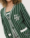 Person wearing a green and white striped cardigan with 'Chasing Balls' text.