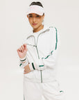 A hand holding a two-toned visor with 'FORE' logo in pink and white colors.