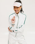 A hand holding a two-toned visor with 'FORE' logo in pink and white colors.