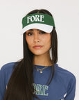 A model wearing a green and white visor with the text 'FORE' across the front.
