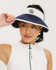 A woman wearing a white and indigo visor with a 'FA' logo on the front.