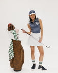 A model wearing a blue and white striped baseball cap with an embroidered logo