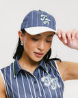 A model wearing a blue and white striped baseball cap with an embroidered logo