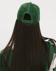 A model wearing a trucker hat with 'Double Bogeys Are Hot' text embroidered on the front, featuring a white mesh back and green visor.