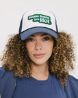 A model wearing an indigo and white hat with the text 'DOUBLE BOGEYS ARE HOT' on the front