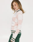 A woman wearing a pink and white checkered intarsia knit sleeveless sweater with a rounded neck.