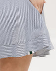 A seersucker skirt with subtle stripes, featuring a flat drawstring, faux buttons down the front, and side seam pockets.