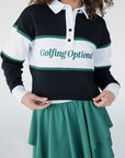 A person wearing a long sleeve polo shirt with horizontal green and white stripes and the text 'Golfing Optional' on the chest, paired with a green skirt.
