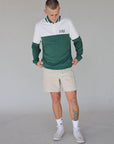 "Close-up of the 'Hamilton Quarter Zip' from the Royal Collection, inspired by autumn hues. This men's quarter zip features complementary color blocking and a convenient zip for easy wear. Made from breathable material, it offers warmth and freedom of movement, ideal for the course and elevating your fall wardrobe with both style and functionality."
