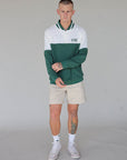 "Close-up of the 'Hamilton Quarter Zip' from the Royal Collection, inspired by autumn hues. This men's quarter zip features complementary color blocking and a convenient zip for easy wear. Made from breathable material, it offers warmth and freedom of movement, ideal for the course and elevating your fall wardrobe with both style and functionality."