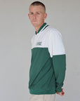 "Close-up of the 'Hamilton Quarter Zip' from the Royal Collection, inspired by autumn hues. This men's quarter zip features complementary color blocking and a convenient zip for easy wear. Made from breathable material, it offers warmth and freedom of movement, ideal for the course and elevating your fall wardrobe with both style and functionality."