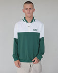 "Close-up of the 'Hamilton Quarter Zip' from the Royal Collection, inspired by autumn hues. This men's quarter zip features complementary color blocking and a convenient zip for easy wear. Made from breathable material, it offers warmth and freedom of movement, ideal for the course and elevating your fall wardrobe with both style and functionality."