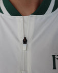 "Close-up of the 'Hamilton Quarter Zip' from the Royal Collection, inspired by autumn hues. This men's quarter zip features complementary color blocking and a convenient zip for easy wear. Made from breathable material, it offers warmth and freedom of movement, ideal for the course and elevating your fall wardrobe with both style and functionality."