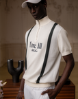 A man wearing a beige zip sweater with vertical green stripes and the text 'Fore All x Khalhon' on the chest.