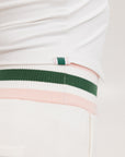 A female model wearing a white sleeveless tank top with a green and pink stripe at the neckline and armholes, and the text 'Chasing Balls' on the chest