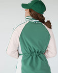 A person wearing a green Elle Rain Jacket with a matching green hat, standing against a white background.