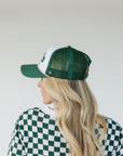 Green and white cap with 'Golfing Optional' and mesh back.