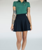 A person wearing a high-waisted black skirt with a green golf shirt. The skirt has side seam pockets and is made of a ribbed fabric.