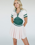 The "Rowie Skirt" is a versatile and timeless wardrobe essential for women. It features a flattering striped elastic waistband and a double-layered design that adds elegance and comfort. Made from stretchy, breathable fabric, this skirt allows for ease of movement, whether on the golf course or during casual outings. A stylish choice for any occasion.
