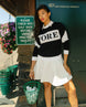 Person wearing a black and white sweater with 'FORE' printed on it