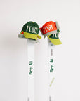 Two hats with 'FORE' text hanging on skis on a white background