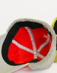 Close-up of a red cap with white text on a white background