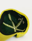 Avocado and green cap with brand logo on a white background
