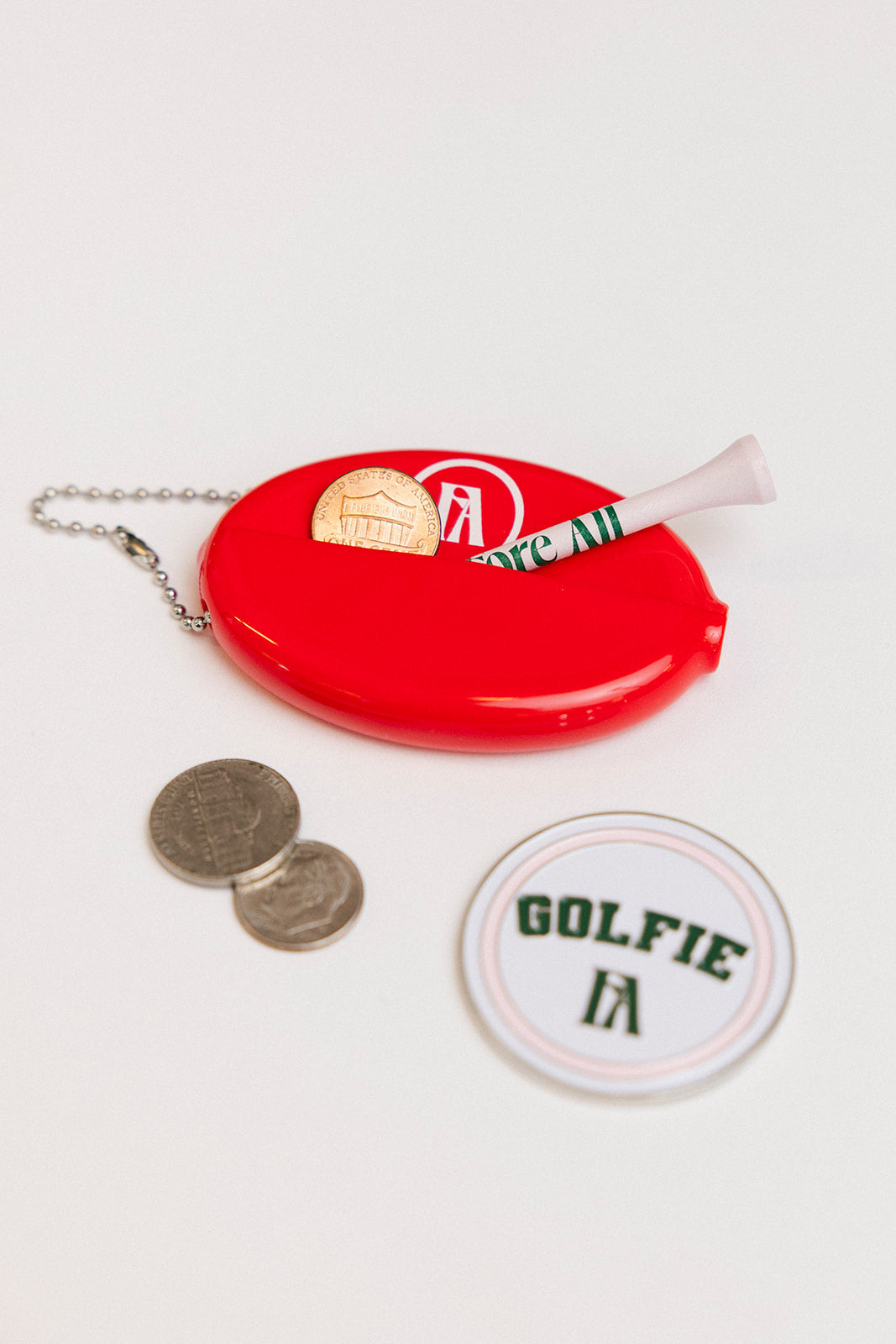 Red oval keychain with &#39;Golf Bum&#39; text on a white background