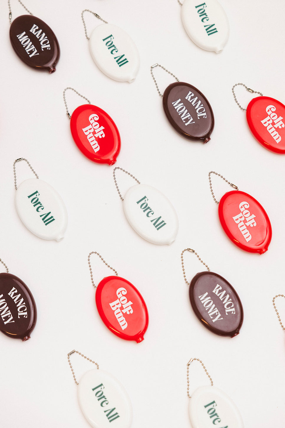 Set of oval-shaped keychains with text on a light background