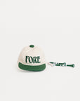 White cap with green brim and 'FORE' text on a white background