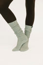 Light gray socks worn with black leggings on a white background