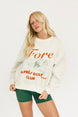 Woman wearing a white sweatshirt with red text and green shorts on a white background