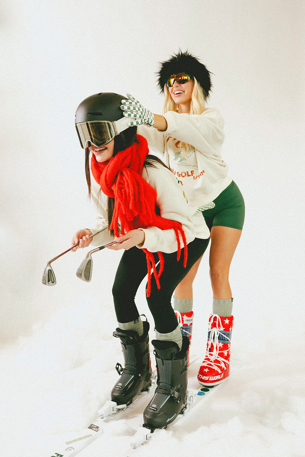 Two people in winter sports gear on a snowy background
