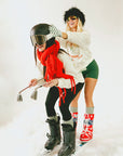 Two people in winter sports gear on a snowy background
