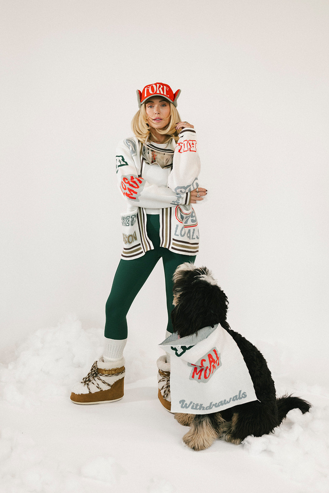 Person wearing a sweater with colorful text and designs on a white background