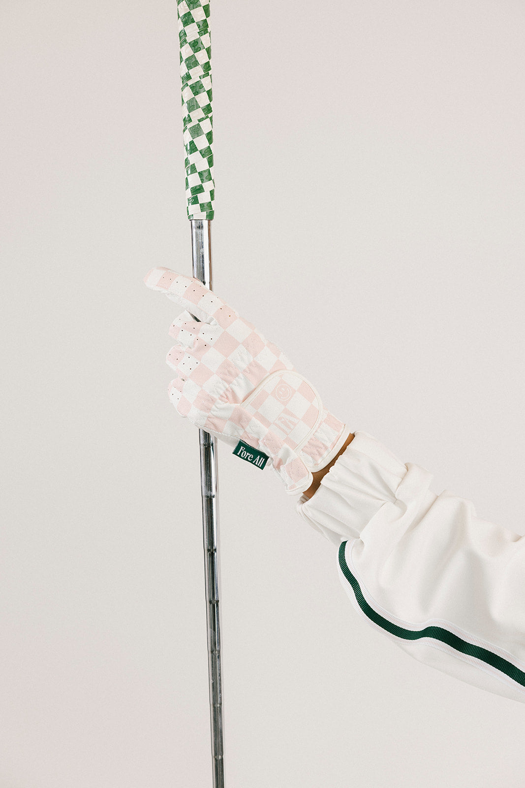 Golf club with a pink glove on a white background