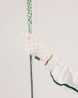 Golf club with a pink glove on a white background