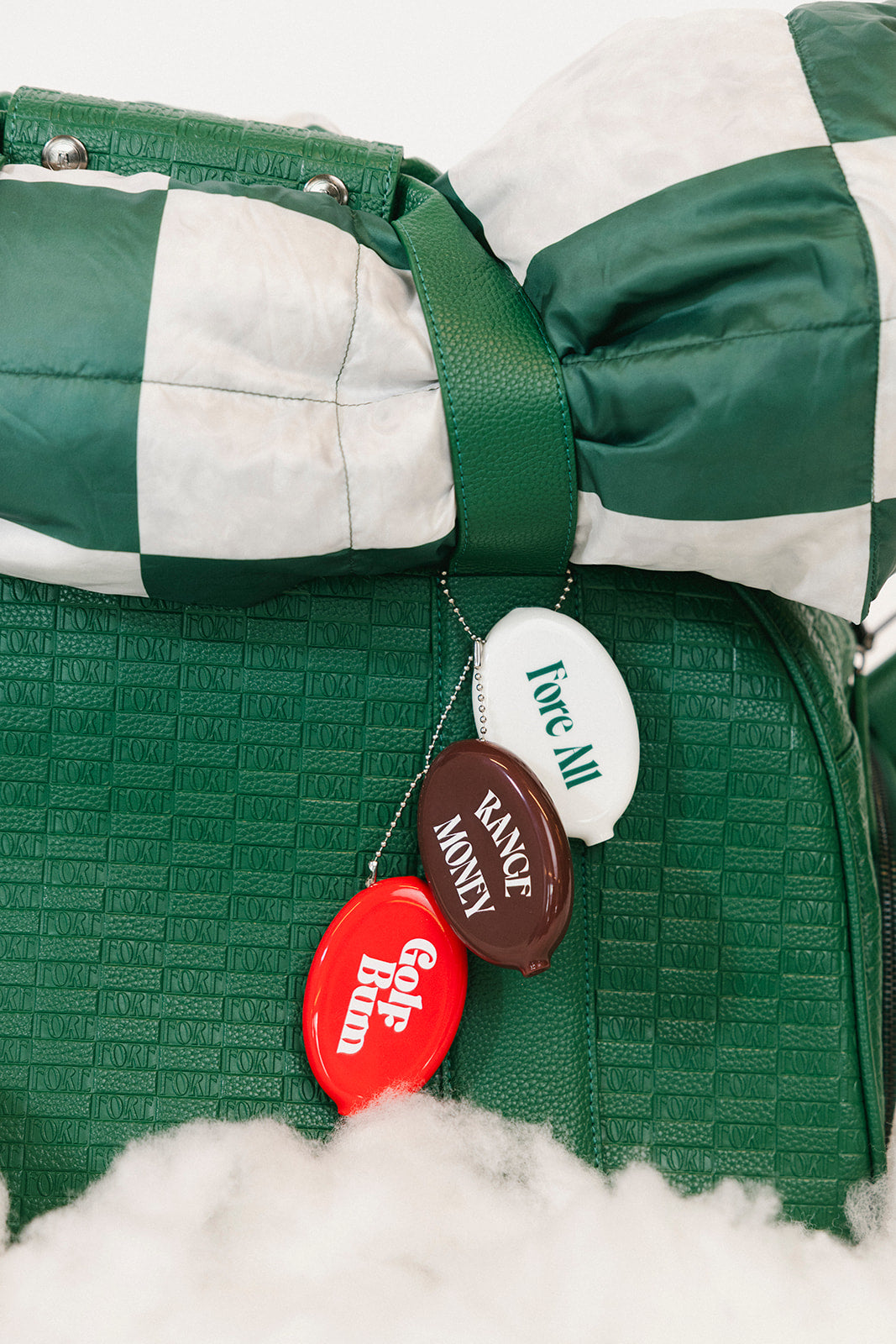Green and white checkered blanket with golf-themed buttons on a white background
