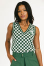 Woman wearing a green and white checkered sleeveless top with a logo on a white background