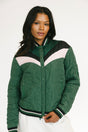 Woman wearing a green quilted jacket with white and black accents on a white background