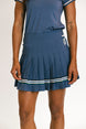 Person wearing a blue pleated skirt with white stripes on a plain background