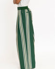 Person wearing green and white striped pants with a white top on a white background
