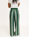 Person wearing green and white striped pants with a white top on a white background