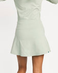 Light green dress worn by a person on a white background