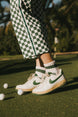 A model wearing a pink and green striped retro ankle sock.