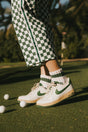 A model wearing a pink and green striped retro ankle sock.
