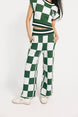 Person wearing a green and white checkered outfit on a white background