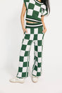 Person wearing a green and white checkered outfit on a white background