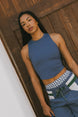 A model wearing the Fore All Lillee Tank in Indigo paired with indigo pants.