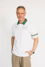 Man wearing a white polo shirt with green accents and '04' on a white background